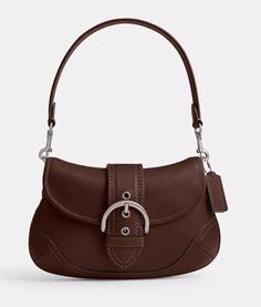 An instant icon by Coach, the Soho bag is a flap-front silhouette with a removable shoulder strap. Inside zip pocket • Magnetic snap closure, fabric lining • Detachable handle with 7 1/4" drop • 10 1/2" (W) x 6 1/4" (H) x 2 3/4" (D) • This item purchased online must be returned to the vendor by mail only. This item cannot be returned to Macy's stores. • Glovetanned leather • Spot clean Includes dust bag Brand new in original packaging 100 Authentic Brown Bags, Coach Bag, Bag Brand, Cute Bag, Online Purchase, Soho, Coach Bags, Snap Closure, Bags Handbags