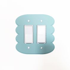 a light switch cover in the shape of a scallop with two white lights