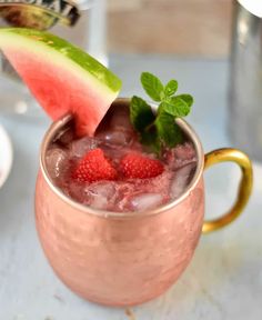 watermelon moscow mule with mint garnish in a copper mug