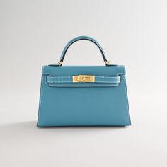 This Kelly, in the Sellier style, is crafted from New Blue Jean Epsom leather with gold hardware and contrast stitching. It features a front toggle closure secured by two straps, a single rolled handle, and a removable shoulder strap for versatile wear. The interior is lined with luxurious lambskin leather and includes an open pocket on the back wall for added convenience. Leather: Epsom Hardware: Gold Style: Kelly Condition: New and never worn (plastic on hardware) Included: Hermès box, Hermès Hermes Jewelry, Hermes Box, Blue Jean, Chanel Handbags, Lambskin Leather, Gold Style, Gold Hardware, Blue Jeans, Shoulder Strap