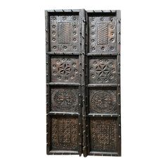 two wooden doors with intricate designs on them