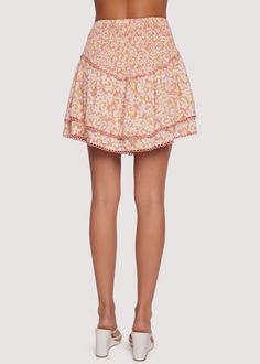 The Coastal Daisies Mini Skirt is designed for a flattering fit and comfortable all-day wear. This mini skirt features a smocked waist with a high-rise fit, a chic asymmetric hem, and a subtle loop trim. It’s perfect for wearing both on special occasions and day-to-day. Complete the look with the matching crop top! WSWS06175-2 Imported 100% Rayon Model is 5 ft 9 inches; Bust: 32", Waist: 23.5", Hips: 35" and wearing a size Small Runs true to size Hand wash or wash with gentle cycle with cold wat Mini Skort With Elastic Waistband For Vacation, Mini Length Skort With Elastic Waistband For Vacation, White Summer Bottoms With Smocked Back, White Vacation Bottoms With Smocked Back, White Smocked Back Bottoms For Vacation, Feminine Summer Bottoms With Smocked Bodice, Feminine Bottoms With Smocked Bodice For Summer, Feminine White Mini Skirt With Elastic Waistband, Trendy White Mini Skirt With Elastic Waistband