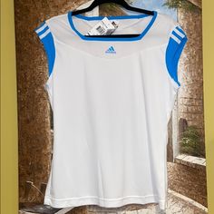 This Is A Truly Pretty T-Shirt! Bright White With The Pretty Adidas Blue Combo. The Logo In The Front Is Raised. The Detail On The Back Is Hot!!! Climacool’s Unique Features With Keep You Dry And Cool, While Looking Ultra Stylish In This Beautiful Top! Size Is L. Blue Sporty Tops For Tennis, Sporty Blue Tennis Tops, Moisture-wicking Tennis Tops For Summer, White Adidas T-shirt With Moisture-wicking, Adidas Moisture-wicking Tops For Workout, Adidas Moisture-wicking Workout Tops, Summer Sports Tops With Three Stripes, Sporty Summer Tennis Tops, Sporty Tennis Tops For Summer