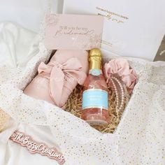 a bottle of wine and some cookies in a gift box with a note on it