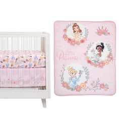 a baby crib with a princess blanket next to it