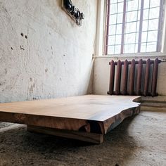 a wooden table sitting in front of a window