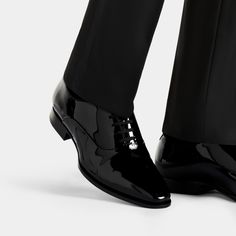 A proper tux isn't complete without a pair of classic black patent leather lace-ups. Thanks to their slim profile, our calf leather Blake-stitched shoes lend a contemporary finish to the traditional black-tie attire. Tuxedo Shoes For Men, Black Patent Shoes, Black Tie Attire, Tuxedo Shoes, Black Patent Leather Shoes, Black Oxfords, Patent Shoes, Black Tuxedo, Patent Leather Shoes