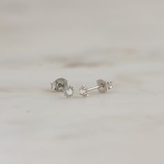 Such a cute, and dainty pair of earrings! They're perfect alone or stacked. They're a tiny pair that are perfect for second piercings, cartilage piercings, or for a minimalist touch. ✤✤ Details ✤✤ ☼ Made of 925 Sterling Silver ☾ We use a THICK plating of 14k Gold or Rhodium for a piece that is sure to last you years to come ★ Sold as a PAIR ☼ Nickel-free & Hypoallergenic ★ Measures 3.5 mm x 3.5 mm ☾ We use the highest grade of cubic zirconia for an authentic diamond look Comes in a cute gift Second Piercings, Tiny Gold Studs, Huggie Earrings Gold, Cartilage Piercings, Small Gold Hoop Earrings, Opal Stud Earrings, Sun Earrings, Small Stud Earrings, Small Gold Hoops