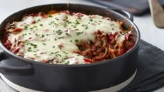 a casserole dish with meat, cheese and sauce