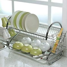 the dish rack is holding dishes in it