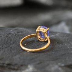 Gold Tanzanite Ring set with a Natural Tanzanite in a top grade, natural inclusions & stunning blue color, at 10x8mm (3 Cts) from Tanzania.Gold Vermeil: 18k Gold over Solid 925 Sterling Silver ☞ made to last.Click here for ☞ Matching EarringsMatching Earrings ☞ please ask meClick here for ☞ Tanzanite - December Birthstone CollectionDetails:• Natural Tanzanite sourced from Brazil• Tanzanite: 10x8mm, 3 Cts, cabochon cut• Band width ≈ 1.9mm, thickness ≈ 1mm• 18k Gold Vermeil ❀ Each Natural Gem is u Oval Tanzanite Gemstones In Prong Setting, Oval Cabochon Tanzanite Jewelry, Oval Tanzanite Cabochon Jewelry, Elegant Opal Ring With Natural Inclusions, Elegant Round Opal Ring With Natural Inclusions, Solitaire Ring Designs, December Birthstone Ring, Gold Solitaire Ring, Jewelry Safe