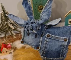 an old pair of jeans has been turned into a dollhouse or figurine