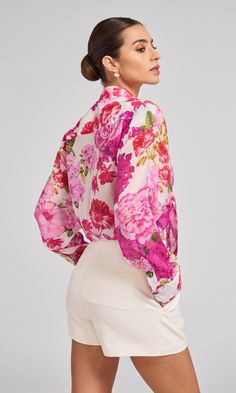 Meet the Benson, our breeziest button-up. Crafted with our new lightweight voile fabric and a colorful floral print, this unlined, semi-sheer top features and oversized silhouette, making it perfect layering with a blazer and trousers for the office or wearing it with a tied front and shorts for a beachside party. Product Fit & Details Self: 80% Rayon, 20% Nylon Professional dry clean Boyfriend fit Length: 30", Sleeve Length: 20 3/4" Style: SU24232-1 Model Size & FitModel wears a size XSModel we Summer Silk Shirt With Floral Print, Feminine Floral Print Button-up Shirt, Feminine Floral Print Blouse For Garden Party, Feminine Floral Print Blouse For Daywear, Silk Shirt With Floral Print For Summer, Chic Pink Blouse For Garden Party, Chic Floral Print Button-up Shirt, Floral Print Long Sleeve Blouse For Garden Party, Long Sleeve Tops For Garden Party