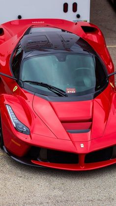 a red sports car parked in a parking lot