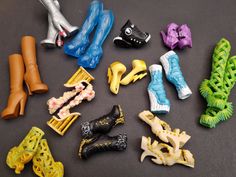 there are many different types of toy shoes on the table, including one with long legs