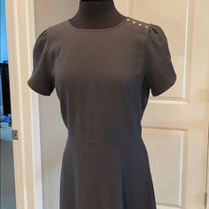 This Cute And Flattering Dress By Loft Is New With Tags, Size 12, A Classic Charcoal Grey, Has Cute Button Detailing And Tulip Sleeves. The Fit And Flare Is A Very Flattering And Forgiving Style For All Shapes And Sizes! Chic Short Sleeve Dress With Button Back, Chic Short Sleeve Button Back Dress, Fitted Knee-length Midi Dress With Button Back, Formal Short Sleeve Mini Dress With Button Closure, Elegant Short Sleeve Button Back Dress, Fitted Workwear Mini Dress With Button Back, Fitted Short Sleeve Dresses With Covered Buttons, Fitted Mini Dress With Button Back For Work, Fitted Dress With Button Back For Work