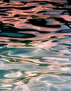 the water is reflecting light from the sun's reflection on it, as well as ripples