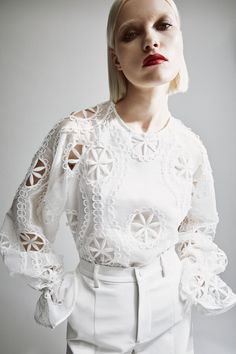 Springtime sophistication. The Rosalee Lace Blouse features an effortless relaxed fit with long volume sleeves, an elasticated frill cuff, high round neckline and allover embroidery details.SIZING: Relaxed fit. AU: Model wears a size 8 / US: Model wears a size 4.FABRICATION: Main base: 100% polyester. Main embroidery: 100% polyester. Lining: 100% cotton. Exclusive of trims.  - Volume sleeves - Elastic frill cuff - Embroidered detail Spring Blouse With Set-in Sleeves, White Lantern Sleeve Blouse With Elastic Sleeves, Spring Long Sleeve Blouse With Set-in Sleeves, White Puff Sleeve Tops With Embroidered Sleeves, Fall White Blouse With Elastic Sleeves, Chic White Blouse With Embroidered Sleeves, Elegant White Blouse With Elastic Sleeves, White Blouse With Elastic Sleeves For Fall, Chic White Blouse With Elastic Sleeves