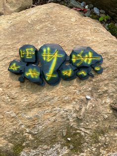 some rocks with graffiti written on them