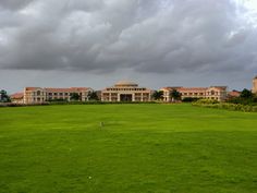 a large building sitting on top of a lush green field