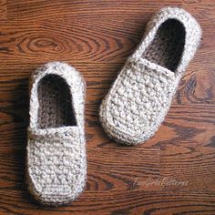 two crocheted slippers sitting on top of a wooden floor