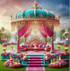 an elaborately decorated bed in the middle of a lush green field with pink and blue flowers