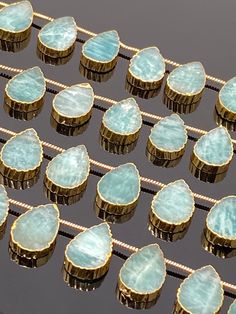 there are many cupcakes with blue frosting on them and gold trimming