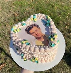 a person holding a cake with a photo on it