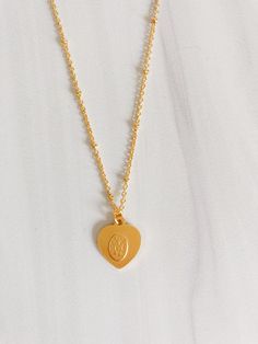 Share your love of the Blessed Virgin Mary with our Heart Shaped Miraculous Medal Necklace. Featuring an 18" chain chain with an image of the Blessed Virgin Mary. Makes a lovely gift for Confirmations or First Holy Communions. 18" chain 14k gold over brass This piece is designed and made by Amano Studio, a small, woman owned jewelry brand and studio based in Sonoma California Miraculous Medal Necklace, Catholic Necklace, Sonoma California, The Blessed Virgin Mary, Catholic Jewelry, Blessed Virgin, Blessed Virgin Mary, Miraculous Medal, First Holy Communion