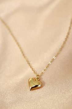 A brass puff heart charm on an 18" gold filled chain. Materials: gold filled chain, brass heart charm Length: 18" long SKU: CN1500G Yellow Gold Heart Charm Necklace In 14k Gold Filled, Valentine's Day Gold-plated Heart Charm Necklace, Gold Charm Necklace With Delicate Chain For Valentine's Day, Dainty Heart-shaped Brass Necklaces, 14k Gold-filled Heart Necklace With Heart Charm, Delicate Gold Heart Pendant Necklace, Dainty 14k Gold Charm Necklace With Heart Charm, Delicate Gold Necklace With Heart Charm, Everyday Gold Plated Heart Necklace