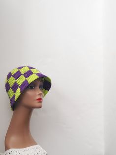 Crochet checkered bucket hat Get ready for your next festival with this handmade checkered bucket hat! The purple and neon green colors give it a unique and eye-catching look that is perfect for a boho or hippie chic style. Made with lightweight and stretchy acrylic crochet fabric, it is comfortable to wear in any season - whether it's winter, summer, fall, or spring. This one size fits all hat is perfect for casual occasions and features accents that give it a stylish touch. The hat is not only fashionable but also practical as it is handmade with high-quality materials. Add this United States made bucket hat to your wardrobe and show off your love for checkered patterns and hippie fashion! Trendy Green Crochet Hat, Trendy Green Crochet Beach Hat, Trendy Green Crochet Hat For Beach, Trendy Green Crochet Hat For The Beach, Green Casual Crochet Hat For Festival, Trendy Handmade Green Crochet Hat, Casual Green Crochet Hat For Festival, Trendy Purple Bucket Hat For Spring, Purple Crochet Beanie For Beach