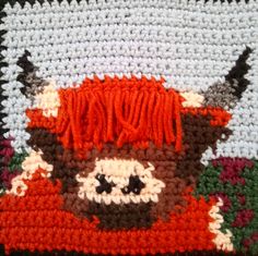 a crocheted blanket with an animal on it