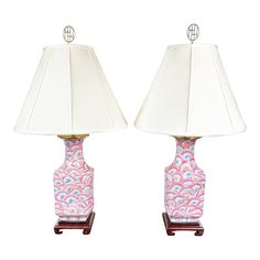 a pair of pink and white lamps sitting next to each other