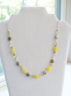 This beautiful necklace is made with 10 mm faceted oval yellow jade, oval nugget yellow quartz, tiny faceted yellow jade spacer beads, 3 mm round white moonstone, and pewter spacer beads. This is a very dainty necklace. It has a lot of charm and would match almost anything.  Gemstones- Yellow Jade, Yellow Quartz, Moonstone Length- 20 inches overall, 12 inches beading and 8 inches beading Jade is said to bring luck, long life, and friendship. Quartz is is calming and peaceful and may help boost the immune system.  Moonstone may bring balance and harmony. Chakra- Solar Plexis; confidence, charisma, adaptability, leadership Because these are natural semi-precious gemstones, each stone is unique in color, and can even vary slightly in size and shape. However, all stones are very similar to the Adjustable Yellow Oval Beaded Jewelry, Yellow Jewelry With Polished Oval Beads, Yellow Oval Polished Bead Jewelry, Yellow Quartz, Yellow Jade, Stone Pictures, White Moonstone, Beautiful Necklace, Quartz Necklace