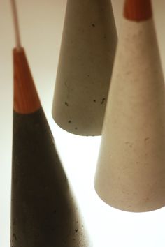 three white and brown vases sitting next to each other