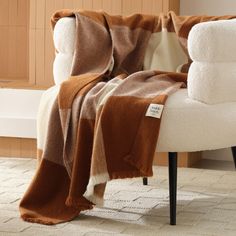 a chair with a brown and white blanket on it