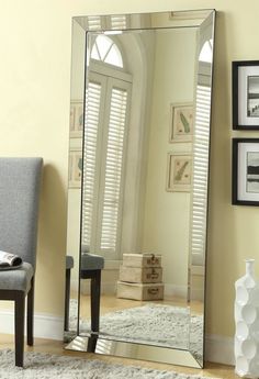 a large mirror sitting on top of a wooden floor