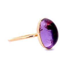 This modern minimalist 1.24 Amethyst Cocktail Ring is crafted in 14K Yellow Gold. A purple treasure to honor Minneapolis. It features a 14 karat yellow gold bezel setting, with a cabochon cut amethyst weighing 1.24 carats. The amethyst is mounted on a thin, yellow gold band, making it a perfect piece for everyday wear. This ring is sure to be a favorite for any minimalist fashion lover. Amethyst symbolizes peace and unity. A gorgeous ring for every day of the week! Amethyst Cocktail Ring, Gorgeous Ring, Metal Shop, Shop Engagement Rings, Gold Band, Cocktail Ring, Yellow Gold Rings, Cocktail Rings, Bezel Setting