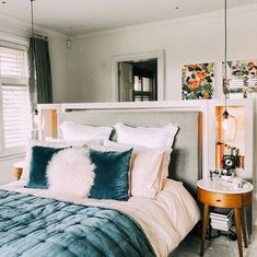 a bed with blue and white pillows in a bedroom