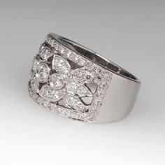 This lovely wide band diamond ring features 61 round brilliant diamonds that grade F-G in color and SI1-2 in clarity. They total 1.08 carats and are set in a floral motif. The ring is crafted of platinum and has a substantial feel. We offer complimentary resizing. Sizing up would be simple. Sizing down may be limited. Contact us with your size. Wide Band Diamond Ring With Brilliant Cut, Elegant Wide Band Diamond Ring, Wedding Wide Band Diamond Ring With Brilliant Cut, Wide Band Diamond Rings, Band Diamond Ring, Platinum Diamond Rings, Platinum Ring, Wide Bands, Brilliant Diamond