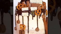 the cake is decorated with chocolate and pretzels