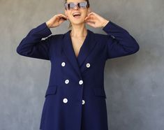 Vintage blue double breasted women long blazer. Front buttons, two pockets and faux chest pocket, lightly padded shoulders (under lining), full lining. Tags are cut off. Fits like size S-M. For reference I'm 5' 6½" / 169 cm tall. Measured laying flat, double for circumference: 29'' / 74 cm long 20'' / 51 cm armpit to armpit 17.5'' / 45 cm waist 15.5'' / 40 cm shoulders seam to seam 24.5'' / 62 cm sleeve length Very good vintage condition. Double-breasted Blazer Dress For Business Casual, Trendy Notch Lapel Blazer Dress For Formal Occasions, Trendy Notch Lapel Blazer Dress For Office, Trendy Office Blazer Dress With Notch Lapel, Trendy Notch Lapel Blazer Dress For Work, Double-breasted Suits With Buttons For Office, Office Blazer Dress With Suit Collar And Buttons, Trendy Single-breasted Blazer Dress For Office, Office Blazer Dress With Suit Collar