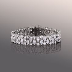 Indulge in the opulent brilliance of this diamond bracelet. By the bold patterned arrangement of round and marquise diamonds, the dazzling optical effect emphasizes each diamond's scintillation.