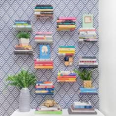 the bookshelves are filled with many different types of books and planters on them