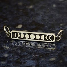 a silver bar with phases on it sitting on top of a blue countertopstone