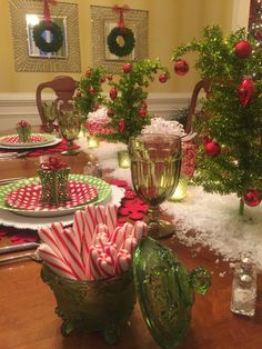 the table is set with candy canes and christmas decorations