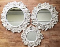 three white mirrors sitting on top of a wooden floor