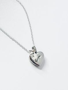 a silver heart shaped pendant on a chain