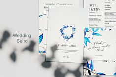 three wedding suite cards with blue flowers on them