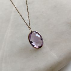 ITEM DESCRIPTION: >>The pendant is made from Solid 14K Yellow Gold. Gemstone used is absolutely natural and ethically sourced. >>Natural Purple Amethyst in briolette cut and oval shape with bezel setting is studded on it with utmost precision. >>This is a minimalist design and is absolutely hassle-free and everyday jewelry. Gem: Purple Amethyst Gem size: 18x13 mm oval fix loop Gem weight: 12.10 carats Gold purity: 14K (58.33% approx.) Gold weight: 0.29 grams Gross weight: 2.71 grams The Gold pur Yellow Gold Amethyst Briolette Jewelry, Yellow Gold Briolette Amethyst Jewelry, Lavender 14k Gold Jewelry For Formal Occasions, Purple Briolette 14k Gold Jewelry, Fine Jewelry In 14k Gold With Lavender Color, Fine Jewelry In Lavender 14k Gold, 14k Gold Oval Necklace In Purple, Elegant Amethyst Necklace With Large Stone, Elegant Large Amethyst Gemstones